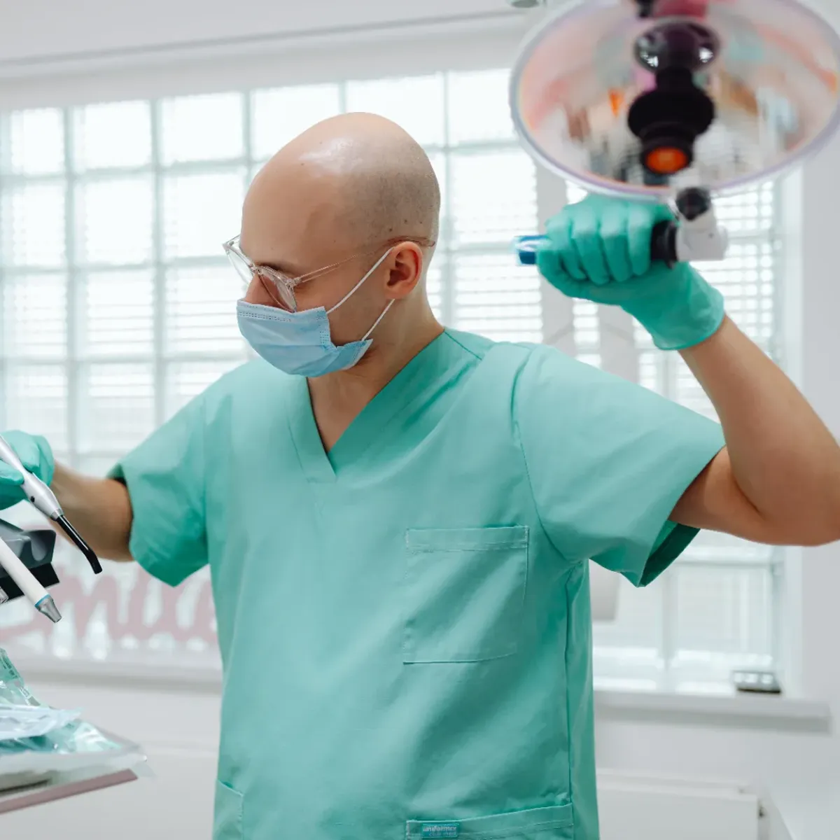 A dentist adjusting the exam light before a procedure